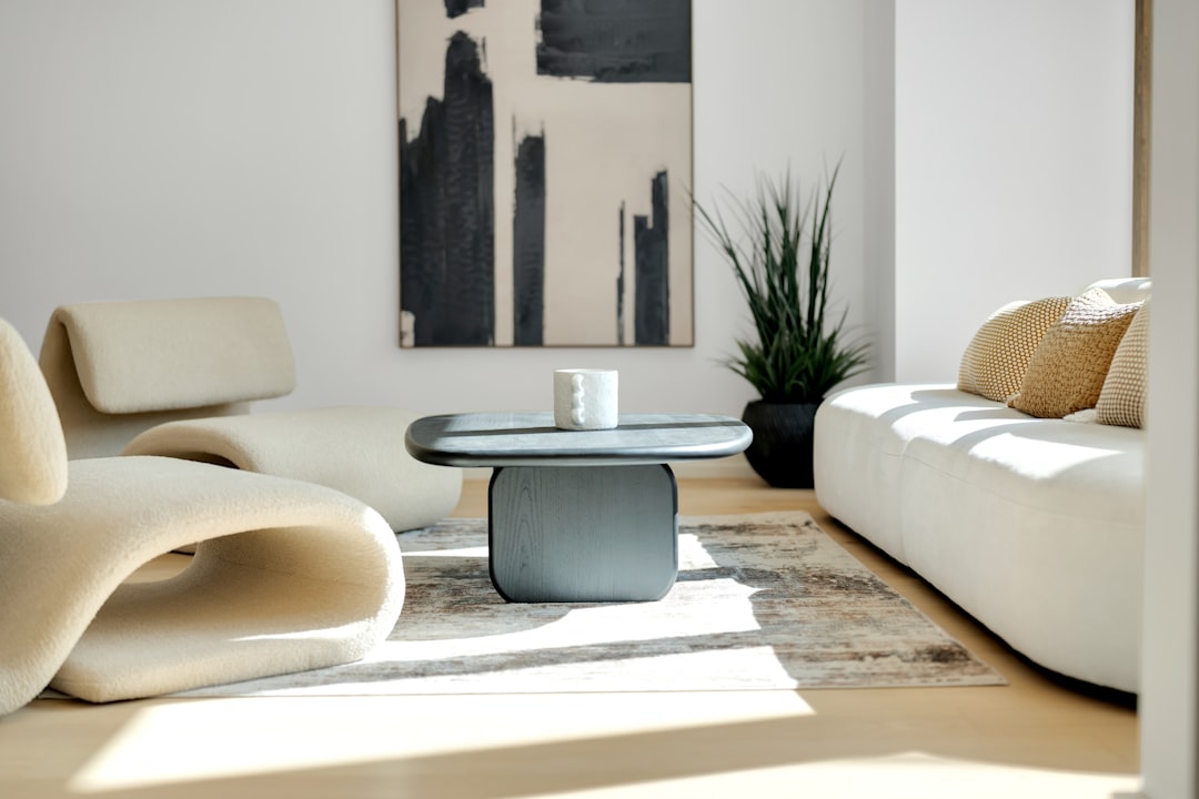 A bright and airy living room, professionally staged with minimalist furniture to appeal to potential home buyers and increase property value.